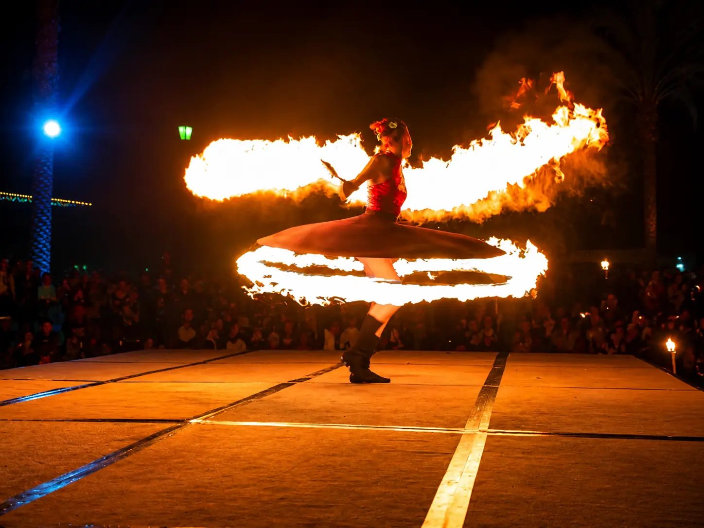 Tabitha spinning the dramatic fire whirling skirt on stage
